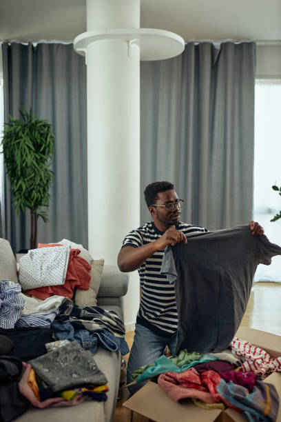 istock Man donating some of his old clothes 1347954008