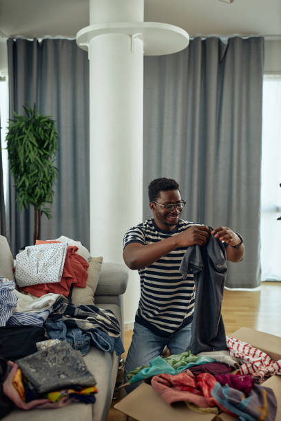 istock Young black male puts donations in a box 1347954077