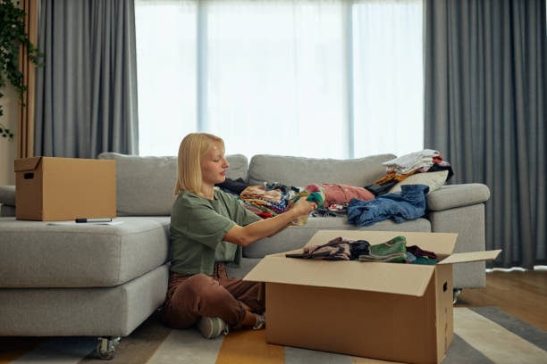 istock Putting clothes into a cardboard box for donation 1347954176