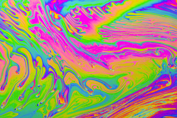 istock Rainbow colors. Psychedelic multi colored patterns background. Photo macro shot of soap bubbles 1347955125