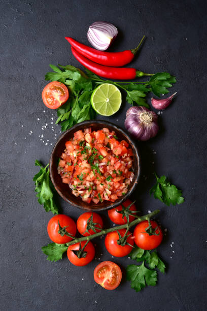 istock Tomato salsa (salsa roja) - traditional mexican sauce  with ingredients for making 1347957995