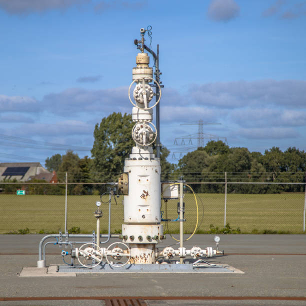 Natural gas well Natural gas wellhead on LNG production station in Groningen, Netherlands. wellhead stock pictures, royalty-free photos & images