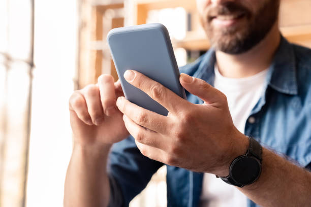 istock Closeup man using smartphone for social media networking, making video call 1347958662