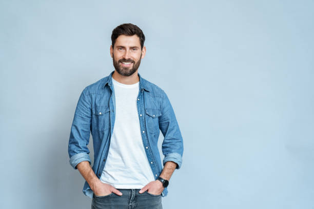 istock Handsome young man isolated on blue background looking at camera and smiling 1347959422