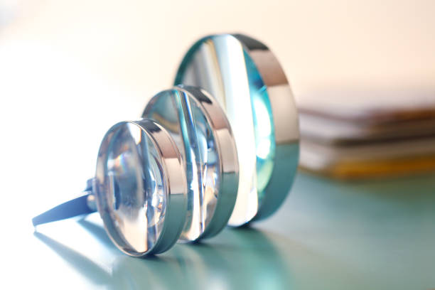 istock Three Magnifying Glasses In A Row In Front Of Stack Of Documents 1347959749