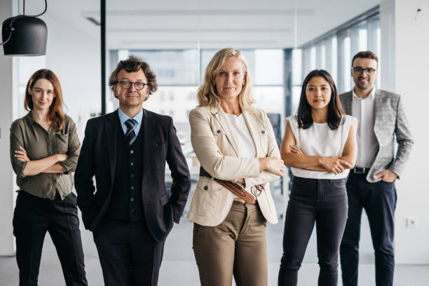istock Business woman posing with her team at work 1347960898