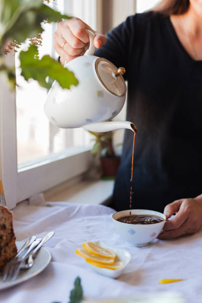 istock Woman pouring coffee from a coffee pot 1347962810