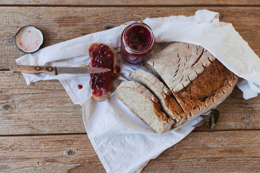 Close-up of a sandwich made of freshly baked homemade bread with butter and fresh plum jam