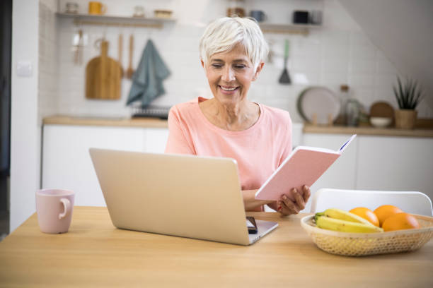 istock Happy old women using laptop 1347966114