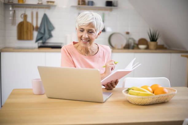 istock Old women with happy face using laptop 1347966119