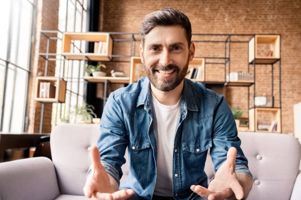 istock Friendly caucasian businessman making video call, looking at camera and talking 1347972035