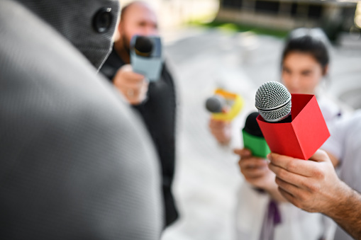 Cairo, Egypt, September 29 2023: Egyptian Media news channel staff with their camera, tripod and equipment, at the sight of Cairo monorail columns and tracks that is still under construction, selective focus