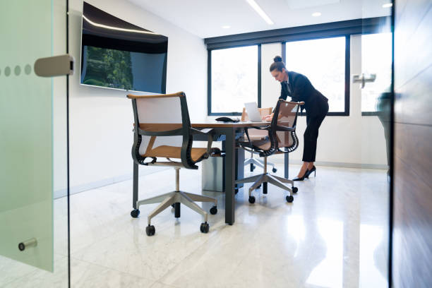 istock Successful business woman in the board room using her laptop computer 1347972917