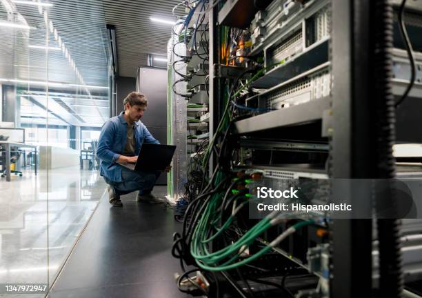 Computer Technician Fixing A Network Server At The Office Stock Photo - Download Image Now
