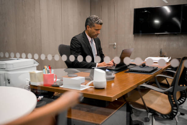 istock Successful business man working in his office using his laptop computer 1347972992