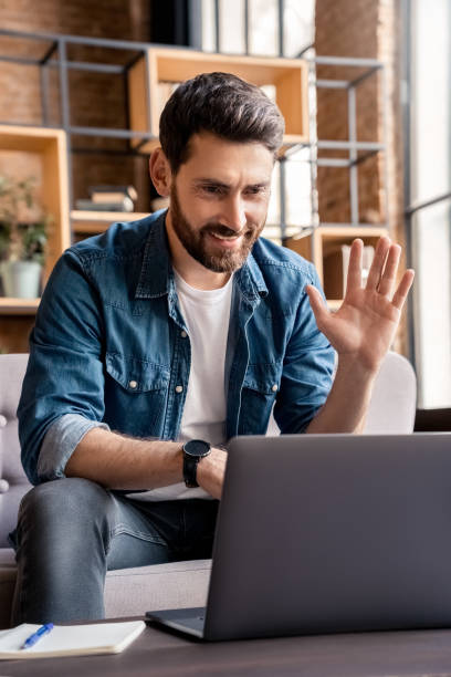 istock Man waving hand holding business video conference greeting interlocutor 1347973587