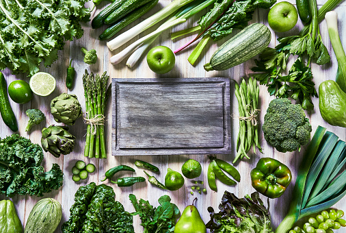 Table top view background of a variation green vegetables for detox and alkaline diet. Set on a white rustic table with copy space