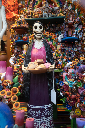 Seoul, South Korea - October 27, 2022: A customer looks at Halloween-themed merchandise on display, as a shopkeeper stands with toys nearby.