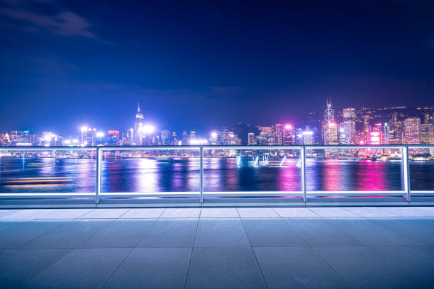 istock Empty brick platform with Hong Kong skyline in background at night 1347976430