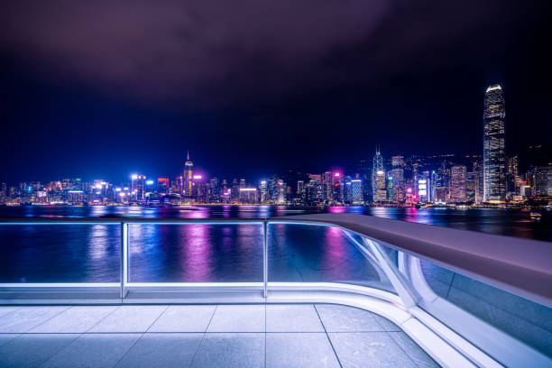 istock Empty brick platform with Hong Kong skyline in background at night 1347976444