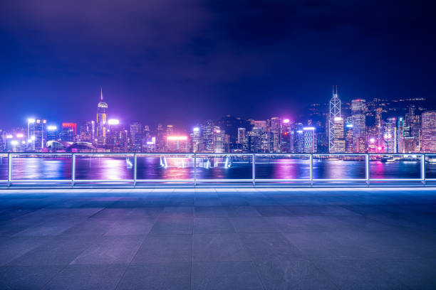 Empty brick platform with Hong Kong skyline in background at night