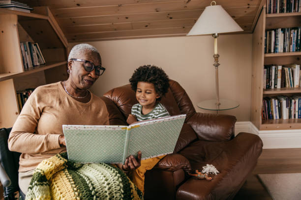 taking care of family members - granny and her grandson - grandparent reading grandmother child imagens e fotografias de stock