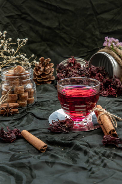 istock Roselle tea (Jamaica sorrel, Rozelle or hibiscus sabdariffa ) with dry roselle and brown cane sugar cube. 1347978013