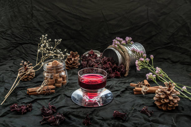 istock Roselle tea (Jamaica sorrel, Rozelle or hibiscus sabdariffa ) with dry roselle and brown cane sugar cube. 1347978018