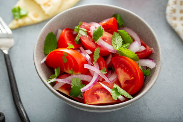 istock Fresh summer salad with tomatoes and red onions 1347980811