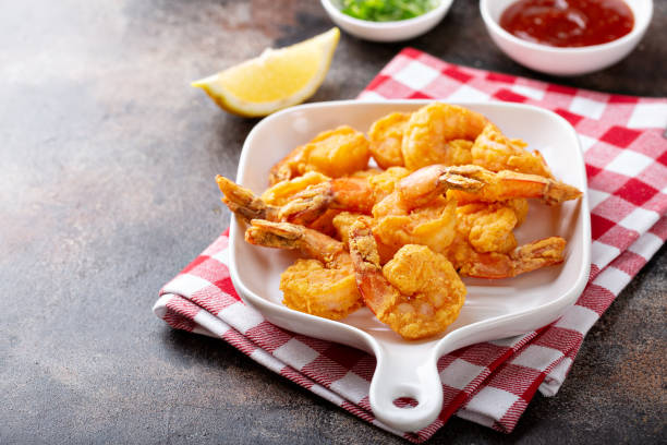 Southern fried shrimp on a platter Southern fried shrimp on a platter with hot sauce cajun food stock pictures, royalty-free photos & images