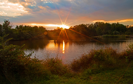 Sunset over Minnesota Lake with Cabins, boats, and pontoon