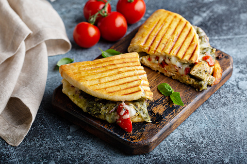 Chicken tomato pesto panini cut in half