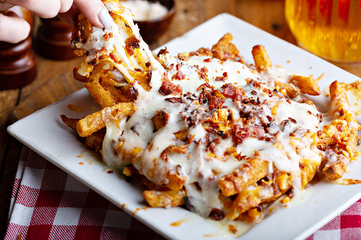 Cheese fries topped with bacon and melted cheese