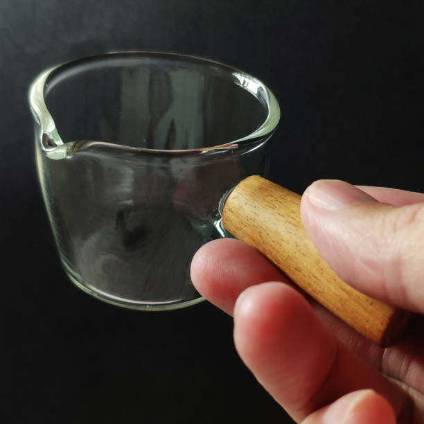 Mini glass cup with wood handle with black color background