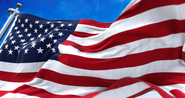 close up view of the american flag waving in the wind stock photo