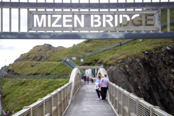 Tourists on Mizen Head Bridge Tourists taking a selfie on Mizen Head Bridge, County Cork, Ireland mizen head stock pictures, royalty-free photos & images