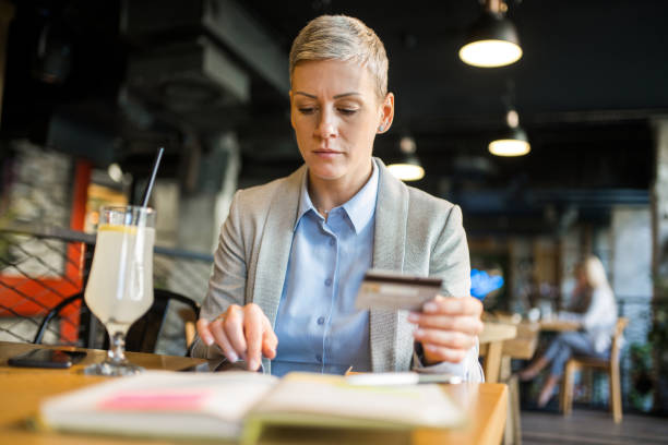 istock Businesswoman using credit card to pay online using digital tablet. 1347993219