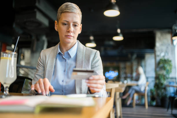 istock Businesswoman using credit card to pay online using digital tablet. 1347993269
