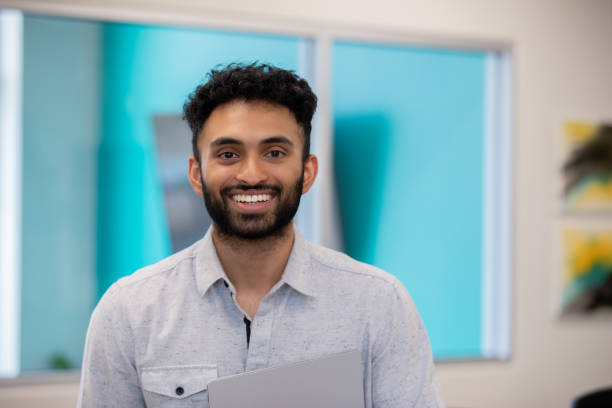 istock Portrait Confident Young Man holding digital tablet 1347993292