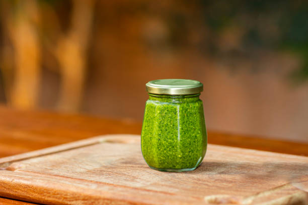 istock Bottle of pesto on the table. 1347993433