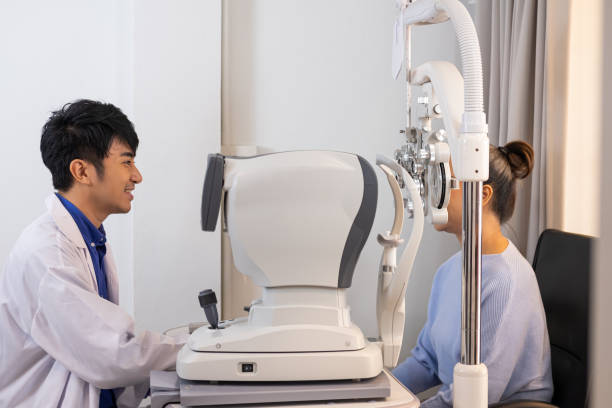 istock Selective focus at Optometrist face. While doctor using medical equipment and subjective refraction to  examine eye visual system of elder patient women with professional machine before made glasses. 1347994178