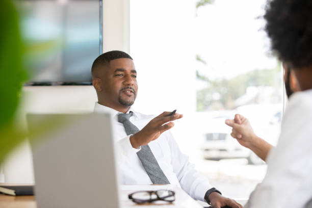 istock Serious Boss talking to employees 1347994968
