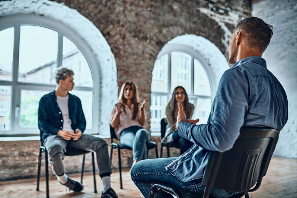 istock Therapist speaking to a rehab group at therapy session. 1347995020