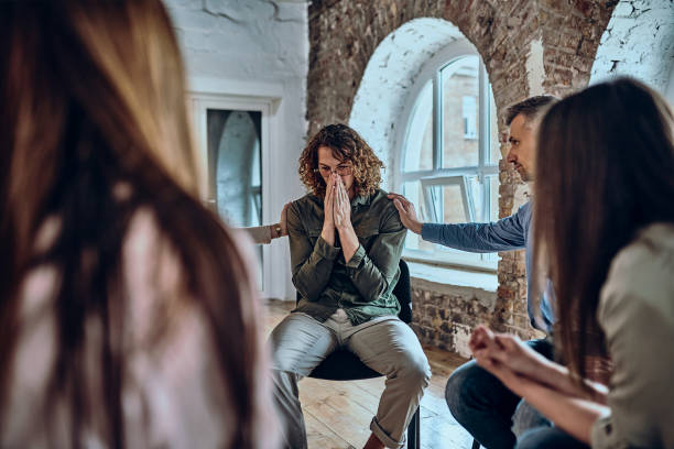 istock Honest conversation in group therapy. Diverse people comforting upset patients helping them deal with grief and other problems. 1347995027