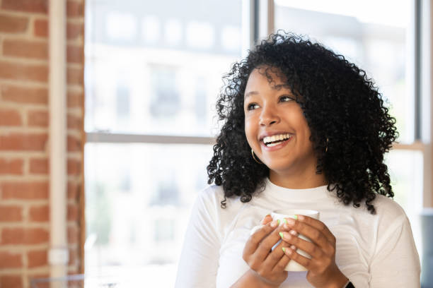 istock Happy Woman holding  coffee mug 1347998251