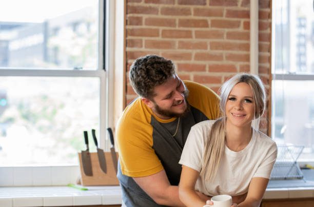 istock Generation Z Couple Hugging in Kitchen 1347998254