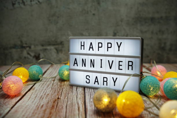 istock Happy Anniversary text on lightbox on wooden background 1347998386