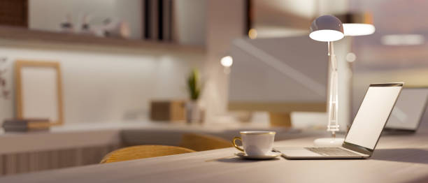 istock Side view of a modern luxury home working space with laptop computer 1348000258