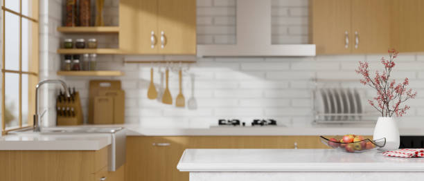 istock Marble kitchen counter island over blurred white and wooden kitchen room. 3d rendering 1348000322