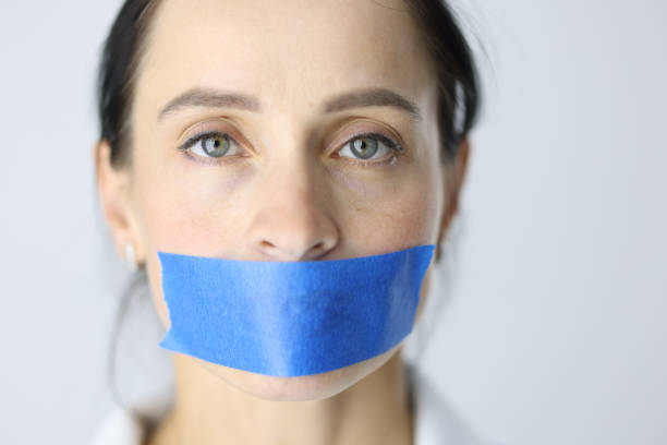 Portrait of young woman with sealed mouth closeup Portrait of young woman with sealed mouth. Feminine silence concept closed mouth stock pictures, royalty-free photos & images